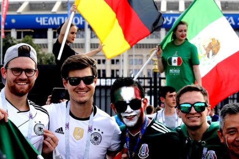 German and Mexico's football fans pose for a photo ahead the group F match between Germany and Mexico at the 2018 soccer World Cup in the Luzhniki Stadium in Moscow, Russia, Sunday, June 17, 2018. (AP Photo/Alexander Zemlianichenko)