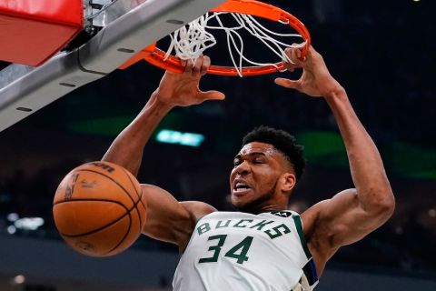 Milwaukee Bucks' Giannis Antetokounmpo dunks during the first half of an NBA basketball game Sunday, March 6, 2022, in Milwaukee . (AP Photo/Morry Gash)