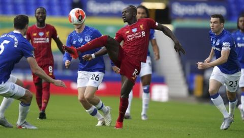 Liverpool's Sadio Mane, center, controls the ball during the English Premier League soccer match between Everton and Liverpool at Goodison Park in Liverpool, England, Sunday, June 21, 2020. (AP photo/Jon Super, Pool)