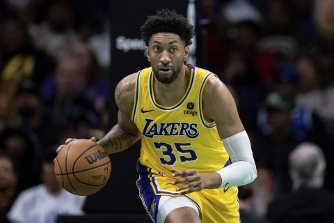 Los Angeles Lakers forward Christian Wood (35) brings the ball up court against the Charlotte Hornets during the second half of an NBA basketball game Monday, Feb. 5, 2024, in Charlotte, N.C. (AP Photo/Jacob Kupferman)