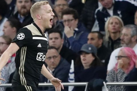 Ajax's Donny van de Beek celebrates scoring his side's first goal during the Champions League semifinal first leg soccer match between Tottenham Hotspur and Ajax at the Tottenham Hotspur stadium in London, Tuesday, April 30, 2019. (AP Photo/Frank Augstein)