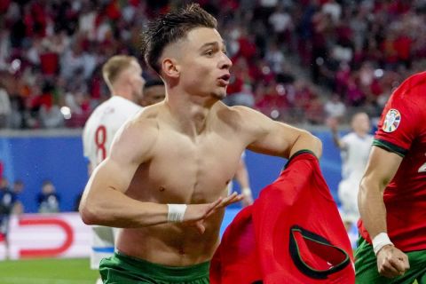 Portugal's Francisco Conceicao, left, celebrates his side's second goal during a Group F match between Portugal and Czech Republic at the Euro 2024 soccer tournament in Leipzig, Germany, Tuesday, June 18, 2024. (AP Photo/Sunday Alamba)