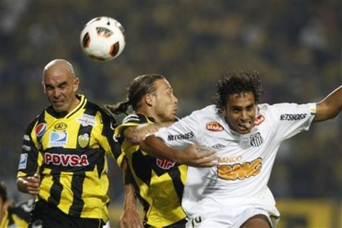 Pedro Fernandez of Venezuela's Deportivo Tachira, left, clears a ball beside his teammate Andres Rouga and Diogo Luis Santo of Brazil's Santos FC in their Copa Libertadores soccer match in San Cristobal, Venezuela, Tuesday Feb. 15, 2011. (AP Photo/Fernando Llano)