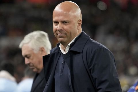 Liverpool's manager Arne Slot and Real Madrid's head coach Carlo Ancelotti, in the background, stand by the touchline before the Champions League opening phase soccer match between Liverpool and Real Madrid at Anfield Stadium, Liverpool, England, Wednesday, Nov. 27, 2024. (AP Photo/Jon Super)