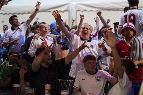 England fans celebrate after the round of sixteen match between England and Slovakia at the Euro 2024 soccer tournament in Gelsenkirchen, Germany, Sunday, June 30, 2024. (AP Photo/Markus Schreiber)