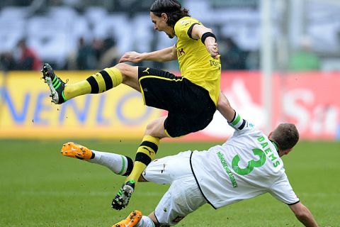 Dortmund's Serbian defender Neven Subotic (L) and Moenchengladbach's Belgian defender Filip Daems vie for the ball during the German first division Bundesliga football match Borussia Moenchengladbach vs Borussia Dortmund in Moenchengladbach, western Germany on February 24, 2013. AFP PHOTO / PATRIK STOLLARZ

DFL RULES TO LIMIT THE ONLINE USAGE DURING MATCH TIME TO 15 PICTURES PER MATCH. IMAGE SEQUENCES TO SIMULATE VIDEO IS NOT ALLOWED AT ANY TIME. FOR FURTHER QUERIES PLEASE CONTACT DFL DIRECTLY AT + 49 69 650050.        (Photo credit should read PATRIK STOLLARZ/AFP/Getty Images)