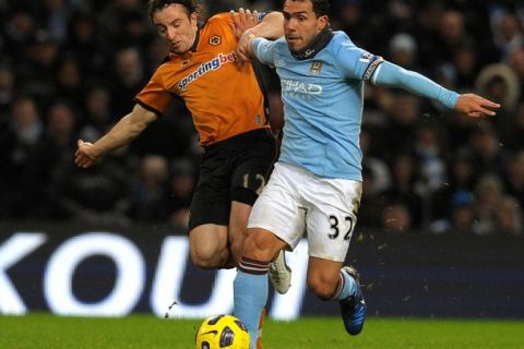 Manchester City's Argentinian striker Carlos Tevez (R) vies with Wolverhampton Wanderers' Irish midfielder Stephen Hunt (L) during the English Premier League football match between  Manchester City and Wolverhampton Wanderers at The City of Manchester Stadium, Manchester, north-west England on January 15, 2011. AFP PHOTO/ANDREW YATESFOR EDITORIAL USE ONLY Additional licence required for any commercial/promotional use or use on TV or internet (except identical online version of newspaper) of Premier League/Football League photos. Tel DataCo +44 207 2981656. Do not alter/modify photo. (Photo credit should read ANDREW YATES/AFP/Getty Images)