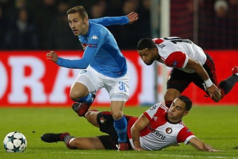 Napoli's Marko Rog, left, escapes Feyenoord's Tonny Vilhena, right, and another unidentified Feyenoord's player during a Champions League Group F soccer match between Feyenoord and Napoli at the Kuip stadium in Rotterdam, Netherlands, Wednesday, Dec. 6, 2017. (AP Photo/Peter Dejong)