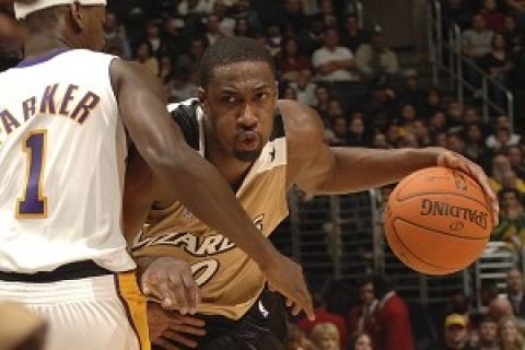 LOS ANGELES, CA - DECEMBER 17: Gilbert Arenas #0 of the Washington Wizards drives to the hoop against Smush Parker #1 of the Los Angeles Lakers on December 17, 2006 at Staples Center in Los Angeles, California.  NOTE TO USER: User expressly acknowledges and agrees that, by downloading and/or using this Photograph, user is consenting to the terms and conditions of the Getty Images License Agreement. Mandatory Copyright Notice: Copyright 2006 NBAE (Photo by Noah Graham/NBAE via Getty Images) *** Local Caption *** Gilbert Arenas 