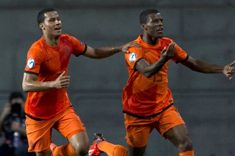 Netherlands' forward Georginio Wijnaldum (R) celebrates with defender Ricardo van Rhijn after scoring a goal against Germany during their 2013 UEFA U-21 Championship group B football match at HaMoshava Stadium in Petah Tikva, north of Tel Aviv, on June 6, 2013. AFP PHOTO / JACK GUEZ        (Photo credit should read JACK GUEZ/AFP/Getty Images)