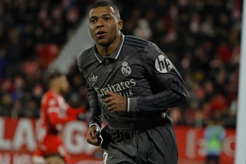 Real Madrid's Kylian Mbappe reacts after scoring his side's third goal during a Spanish La Liga soccer match between Girona and Real Madrid at the Montilivi stadium in Girona, Spain, Saturday, Dec. 7, 2024. (AP Photo/Joan Monfort)