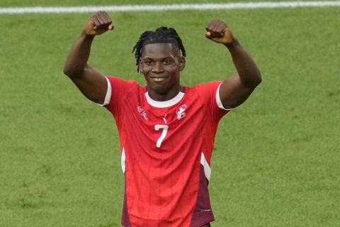 Switzerland's Breel Embolo celebrates after scoring his side's opening goal during a quarterfinal match between England and Switzerland at the Euro 2024 soccer tournament in Duesseldorf, Germany, Saturday, July 6, 2024. (AP Photo/Andreea Alexandru)