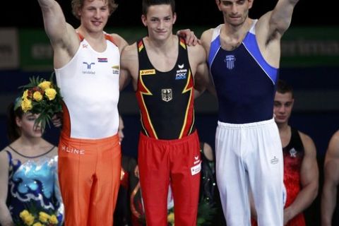 (L to R) Second placed Epke Zonderland of the Netherlands, first placed Marcel Nguyen of Germany and third placed Vasileios Tsolakidis of Greece pose during a flower ceremony after the parallel bars competition at the men's apparatus finals during the Artistic Gymnastics European Championships in Berlin April 10, 2011.         REUTERS/Thomas Peter (GERMANY  - Tags: SPORT GYMNASTICS)  