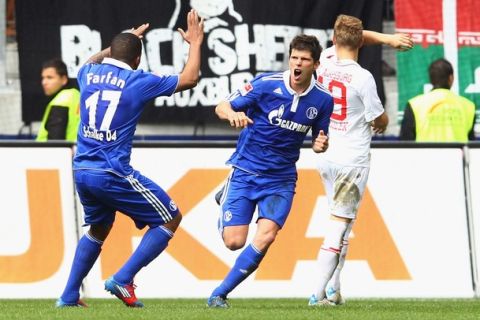 AUGSBURG, GERMANY - APRIL 22:  Klaas-Jan Huntelaar (C) of Schalke celebrates scoring the first team goal with his team mate Jefferson Farfan during the Bundesliga match between FC Augsburg and FC Schalke 04 at SGL Arena on April 22, 2012 in Augsburg, Germany.  (Photo by Alexander Hassenstein/Bongarts/Getty Images)