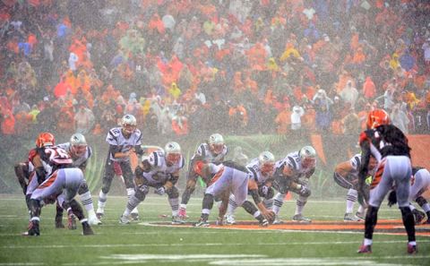 Oct 6, 2013; Cincinnati, OH, USA; New England Patriots quarterback Tom Brady (12) prepares to take a snap in the rain against the Cincinnati Bengals at Paul Brown Stadium. The Bengals won 13-6.  Mandatory Credit: Marc Lebryk-USA TODAY Sports ORG XMIT: USATSI-132684 ORIG FILE ID:  20131006_jla_bl1_266.jpg