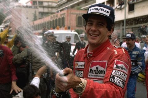 FILE - In this May 12, 1990, file photo, Brazilian driver Ayrton Senna sprays champagne on the photographers to celebrate his career's 30th victory at the Monaco Formula One Grand Prix May 12, 1990.  Brazils adoration of Ayrton Senna transcends sports. Its something only someone like Pele can relish in the country of football. When hundreds of thousands of people lined up for hours just to take a final glimpse of Ayrton Sennas body before his funeral, they were paying tribute to more than a three-time Formula One champion. They were saying farewell to arguably the countrys greatest sporting idol. (AP Photo/Lionel Cironneau,File)