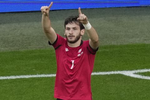 Georgia's Khvicha Kvaratskhelia celebrates after scoring his side's opening goal during a Group F match between Georgia and Portugal at the Euro 2024 soccer tournament in Gelsenkirchen, Germany, Wednesday, June 26, 2024. (AP Photo/Andreea Alexandru)