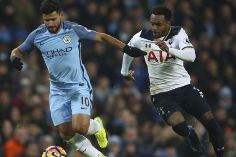 Manchester City's Sergio Aguero, left holds off the challenge of Tottenham Hotspur's Danny Rose during the English Premier League soccer match between Manchester City and Tottenham Hotspur at the Etihad stadium in Manchester, England, Saturday, Jan., 21, 2017. (AP Photo/Dave Thompson)