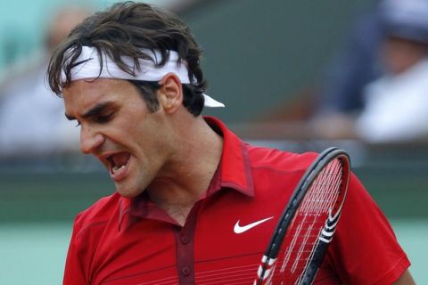 Switzerland's Roger Federer reacts after winning the first set as he plays with Serbia's Novak Djokovic during a semi final at the French Open tennis championship at the Roland Garros stadium, on June 3, 2011, in Paris.   AFP PHOTO / PATRICK KOVARIK (Photo credit should read PATRICK KOVARIK/AFP/Getty Images)