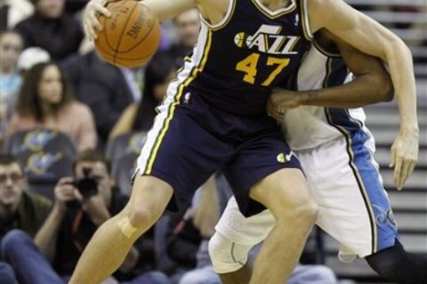 Utah Jazz forward Andrei Kirilenko (47) from Russia, gets past Washington Wizards guard Nick Young in the first half of an NBA basketball game in Washington Monday, Jan. 17, 2011. (AP Photo/Alex Brandon)