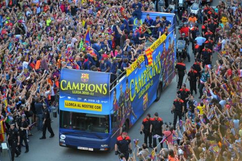 Barcelona's players celebrate on the streets of Barcelona on May 13, 2011 after winning the Spanish League title. Barcelona were crowned Spanish champions for the third successive season with a 1-1 draw at Levante on May 11, 2011, clinching a 21st domestic title with two games to spare. The banne ron the bus reads "Lorca is our hearts." AFP PHOTO/ LLUIS GENE (Photo credit should read LLUIS GENE/AFP/Getty Images)