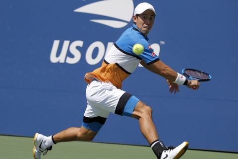 Kei Nishikori, of Japan, returns a shot to Alex de Minaur, of Australia, during round three of the US Open tennis championships Friday, Aug. 30, 2019, in New York. (AP Photo/Eduardo Munoz Alvarez)