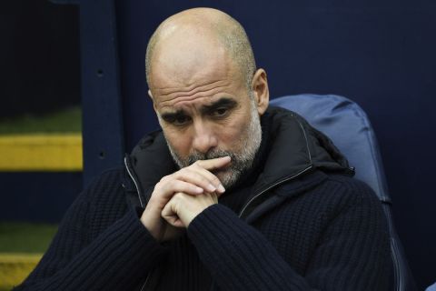 Manchester City's head coach Pep Guardiola sits on the bench prior to the English Premier League soccer match between Manchester City and Everton at the Etihad stadium in Manchester, Thursday, Dec. 26, 2024. (AP Photo/Rui Vieira)