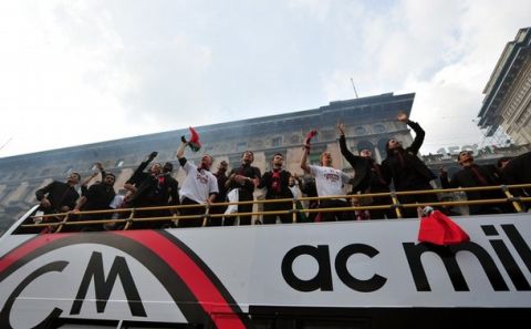 AC Milan players celebrate as they parade on a bus after winning the Scudetto, the Italian football Serie A championship on May 14, 2011 in central Milan. AC Milan claimed their 18th Serie A title.  AFP PHOTO / GIUSEPPE CACACE (Photo credit should read GIUSEPPE CACACE/AFP/Getty Images)