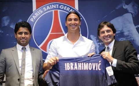 Paris Saint-Germain (PSG) football club's newly recruited Sweden striker Zlatan Ibrahimovic (C), poses with his new jersey next to Paris Saint-Germain (PSG) football club's chairman Nasser Al-Khelaifi (L) and PSG's Brazilian sporting director Leonardo during a press conference as part of Ibrahimovic's official presentation at the Parc des Princes on July 18, 2012 in Paris.  AFP PHOTO / BERTRAND GUAY        (Photo credit should read BERTRAND GUAY/AFP/GettyImages)