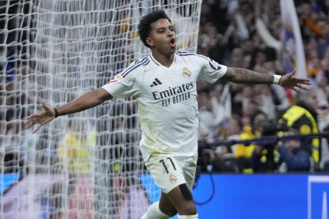 Real Madrid's Rodrygo celebrates after scoring his side's third goal during the Spanish La Liga soccer match between Real Madrid and Sevilla at the Santiago Bernabeu Stadium in Madrid, Spain, Sunday, Dec. 22, 2024. (AP Photo/Bernat Armangue)