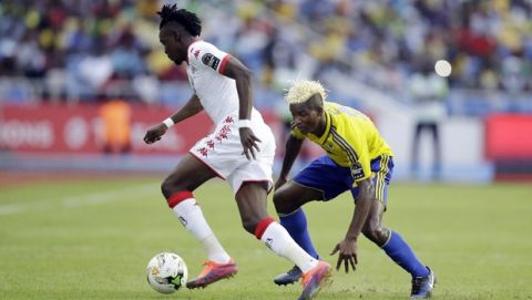 Gabon's Pierre Didier Ndong, right, challenges Burkina Faso's Betrand Traore for the ball during the African Cup of Nations Group A soccer match between Gabon and Burkina Faso at the Stade de l'Amitie, in Libreville, Gabon on Wednesday Jan. 18, 2017. (AP Photo/Sunday Alamba)