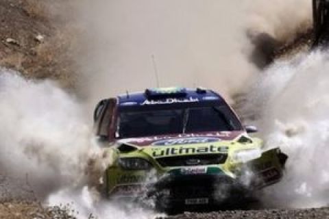 Finland's Mikko Hirvonen and his co- driver Jarmo Lahtinen drive though water with their Ford Focus, at Aghii Theidori near Loutraki about 80 kilometers (50 miles) southwest of Athens during the third day of the WRC, Acropolis Rally, Sunday, June 14, 2009. (AP Photo/Petros Giannakouris)