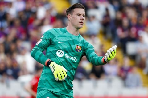 Barcelona's goalkeeper Marc-Andre ter Stegen hands over the ball during a Spanish La Liga soccer match between Barcelona and Rayo Vallecano at the Olimpic Lluis Companys stadium in Barcelona, Spain, Sunday, May 19, 2024. (AP Photo/Joan Monfort)