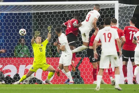 Turkey's Merih Demiral, top, heads the ball to scores his side's second goal during a round of sixteen match between Austria and Turkey at the Euro 2024 soccer tournament in Leipzig, Germany, Tuesday, July 2, 2024. Austria's goalkeeper Patrick Pentz is at left. (AP Photo/Martin Meissner)