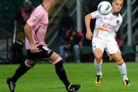 Lecce's Algerian midfielder Djamel Mesbah, right, challenges for the ball with Palermo's midfielder Giulio Migliaccio during their Serie A soccer match at the Renzo Barbera stadium in Palermo, Italy, Thursday, Oct. 27, 2011. (AP Photo/Alessandro Fucarini) 