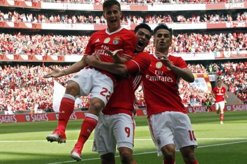 Benfica's Franco Cervi, left, celebrates with teammates Raul Jimenez and Jonas, right, after scoring the opening goal during a Portuguese league soccer match between Benfica and Vitoria de Guimaraes at the Luz stadium in Lisbon, Saturday, May 13, 2017. (AP Photo/Pedro Rocha)