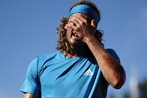 Greece's Stefanos Tsitsipas reacts after missing a shot against Switzerland's Stan Wawrinka during their fourth round match of the French Open tennis tournament at the Roland Garros stadium in Paris, Sunday, June 2, 2019. (AP Photo/Christophe Ena )