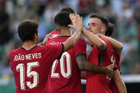 Portugal's Diogo Jota, right, celebrates with his teammates after scoring the second goal against Finland during an international friendly soccer match between Portugal and Finland at the Alvalade stadium in Lisbon, Tuesday, June 4, 2024. (AP Photo/Armando Franca)