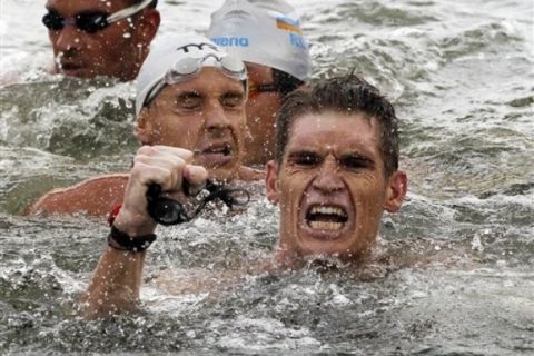 Greece's Spyros Gianniotis celebrates after winning the men's 10km Open Water swimming event at the FINA Swimming World Championships at Jinshan Beach in Shanghai, China, Wednesday, July 20, 2011.  The Greek swimmer finished in 1 hour, 54 minutes, 24.7 seconds. (AP Photo/Ng Han Guan)