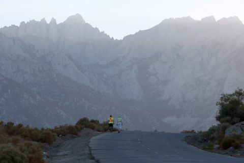 DEATH VALLEY NATIONAL PARK, CA JULY 16:  Iris Cooper-Imhof (R) of Canada walks toward Mount Whitney (L) during the ascent of Whitney Portal Road to the finish of the AdventurCORPS Badwater 135 ultra-marathon race on July 16, 2013 outside of Death Valley National Park, California. Billed as the toughest footrace in the world, the 36th annual Badwater 135 starts at Badwater Basin in Death Valley, 280 feet below sea level, where athletes begin a 135-mile non-stop run over three mountain ranges in extreme mid-summer desert heat to finish at 8,350-foot near Mount Whitney for a total cumulative vertical ascent of 13,000 feet. July 10 marked the 100-year anniversary of the all-time hottest world record temperature of 134 degrees, set in Death Valley where the average high in July is 116. A total of 96 competitors from 22 nations are attempting the run which equals about five back-to-back marathons. Previous winners have completed all 135 miles in slightly less than 24 hours.  (Photo by David McNew/Getty Images)