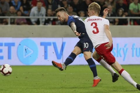 Slovakia's Albert Rusnak, left, scores his side's second goal beside Denmark's Nicolai Johansen during a friendly soccer match between Slovakia and Denmark in Trnava, Slovakia, Wednesday, Sept. 5, 2018. Every player in Denmark's squad are uncapped following a dispute between Denmark's star players and the Danish Football Association. (AP Photo/Ronald Zak)