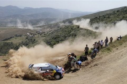 Citroen Total World Rally team's pilot Sebastien Ogier and co-driver Julien Ingrassia, both from France, compete during the Klenia-Mycenea stage of the WRC Acropolis Rally of Greece, near Korinth, Greece, Saturday, June 18, 2011. (AP Photo/Petros Giannakouris)