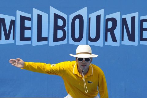 FILE - In this Jan. 21, 2011 file photo, A linesman gestures that a ball is out during a third round match between Spain's Nicolas Almagro and Croatia's Ivan Ljubicic at the Australian Open tennis championships in Melbourne, Australia. In a Grand Slam-first, at the 2021 Australian Open tennis championships, there will be no on-court line judges on any of the tournament courts in an effort to reduce the number of staff on-site due to coronavirus-related concerns. Only chair umpires and ball persons will be on the court. (AP Photo/Andrew Brownbill,File)